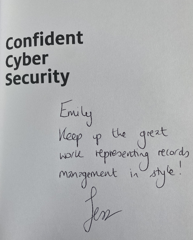 Screenshot of the first book page with Confident Cyber Security with a handwritten note that says "Emily, Keep Up the great work representing records management in style! Jess"